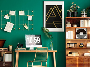 Pop_culture_study_bold_green_feature_wall_timber_desk_bookshelf_gold_hanging_artwork_books